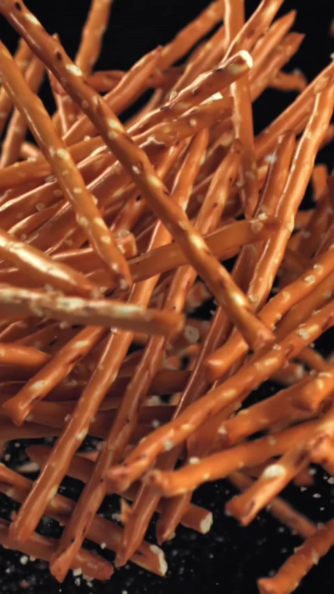 Salted cracker sticks fly and fall. Filmed on a high-speed camera at 1000 fps Stock Footage 335370695