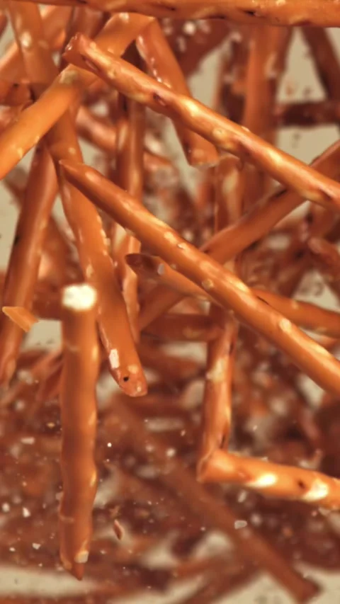 Salted cracker sticks fly and fall. Filmed on a high-speed camera at 1000 fps Stock Footage 335371722