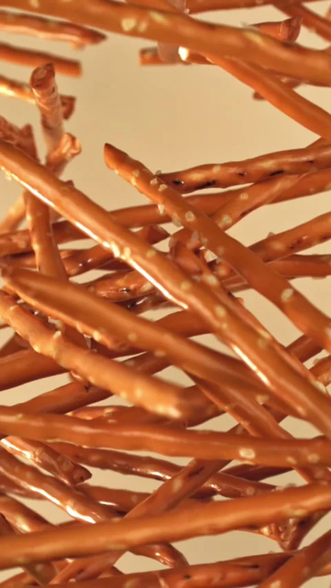Salted cracker sticks fly and fall. Filmed on a high-speed camera at 1000 fps Stock Footage 335379499