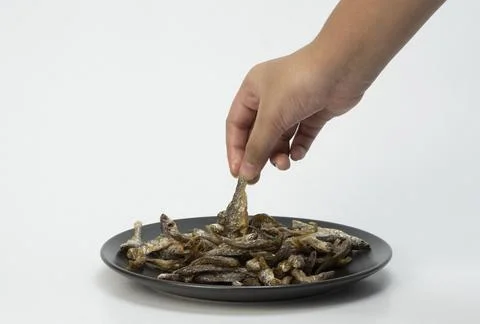 Salted fish on a ceramic plate Stock Photos