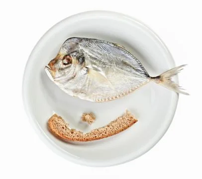 Salted moonfish with crust of bread on white plate Stock Photos