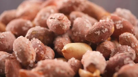Salted peanuts macro footage rotating on dark surface close up of roasted s.. 스톡 동영상 332910798