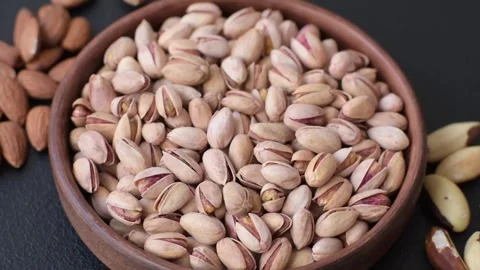 Salted pistachio nuts in shells as a healthy, high calorie food ingredient. Pist Stock Footage 329889233