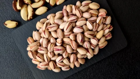 Salted pistachio nuts in shells as a healthy, high calorie food ingredient. Pist 動画素材 329889298