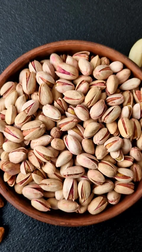 Salted pistachio nuts in shells as a healthy, high calorie food ingredient. Pist Stock Footage 329889326