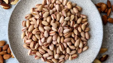Salted pistachio nuts in shells as a healthy, high calorie food ingredient. Pist 動画素材 329889348