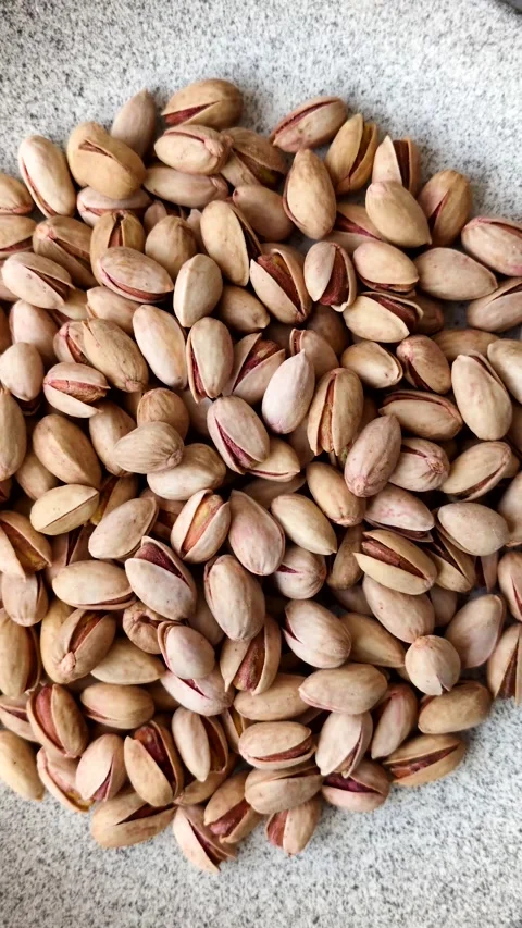 Salted pistachio nuts in shells as a healthy, high calorie food ingredient. Pist 動画素材 329889351