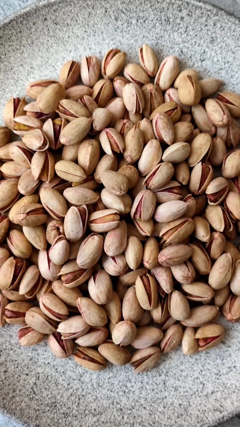 Salted pistachio nuts in shells as a healthy, high calorie food ingredient. Pist Stock Footage 329889352
