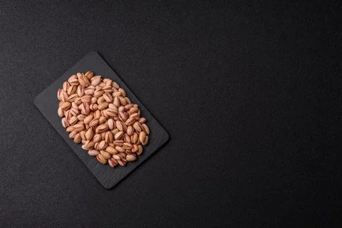 Salted pistachio nuts in shells as a healthy, high calorie food ingredient... Stock Photos