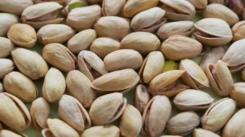 Salted Pistachios for Beer, Macro, Spin. Isolated Background of a Beer Snack of  Stock Footage 155332390