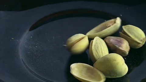 Salted pistachios in a plate Stock Footage 73826465