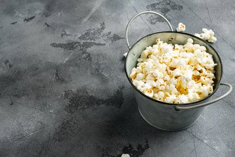 Salted popcorn on gray stone table background, with copy space for text Stock Photos