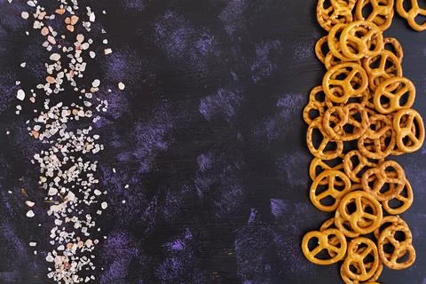 Salted pretzel on dark background Stock Photos