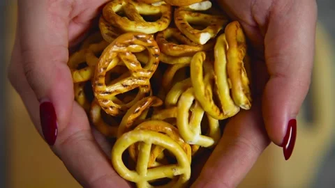 Salted pretzels fall on a cutting board Stock Footage 194277356