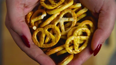 Salted pretzels fall on a cutting board Video stock 194277359