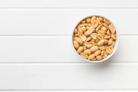 Salted roasted peanuts. Salted roasted peanuts in bowl. Copyright: xZoonar... Stock Photos