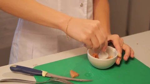 Salted salmon, Laboratory assistant kneading fish in a mortar Stock Footage 74578372
