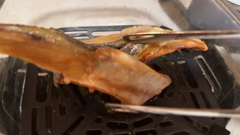 Salted smelly fermented Basa fish grilled in Air Fryer Stock Footage 336700584