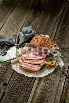 Salted smoked bacon on paper with kitchen towel hatchet leaves cuisine cookin Stock-Fotos