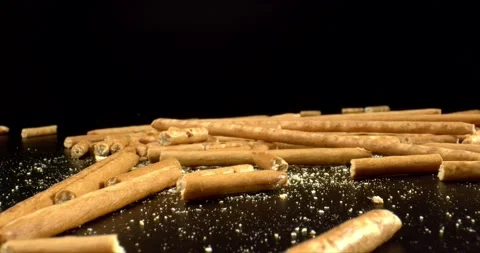 Salted Sticks Thrown Up. Bread sticks with salt lies on black surface. Delicious Video stock 147036613