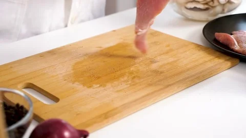 Salting and puting pepper on a delicious piece of meat Stock Footage 85361477