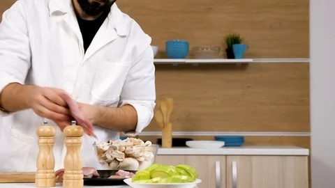 Salting and puting pepper on raw pieces of meat Stock Footage 85361603