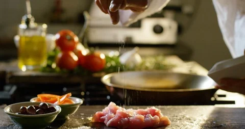Salting bits of raw meat 4k Stock Footage 85836085