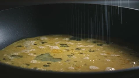 Salting eggs in a pan Stock Footage 166863168