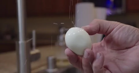 Salting a Hard Boiled Egg in Slow Motion Stock Footage 333669811