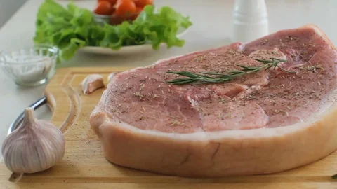 Salting a Steak in the Kitchen Before Cooking Stock Footage 87270057