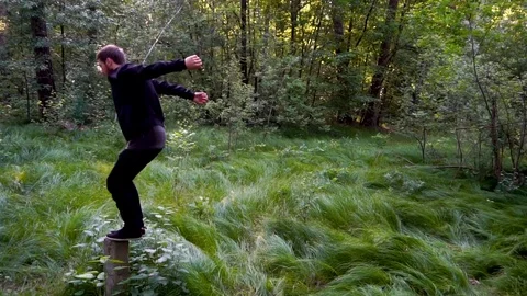 Salto in the forest with a landing on the grass Stock Footage 80319411