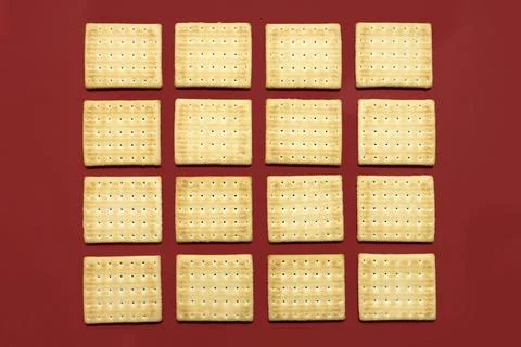 Salty cracker pattern on maroon red background Stock Photos
