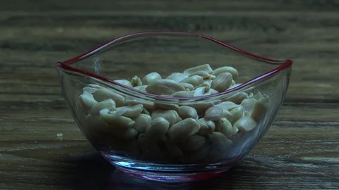 Salty land hazelnuts fall into cup 스톡 동영상 79310311