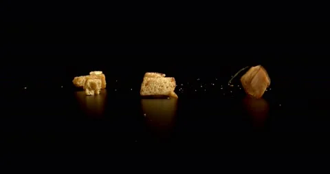 Salty oiled Bread crumbs falling on black background. Crackers Food Crisps Stock Footage 147036016