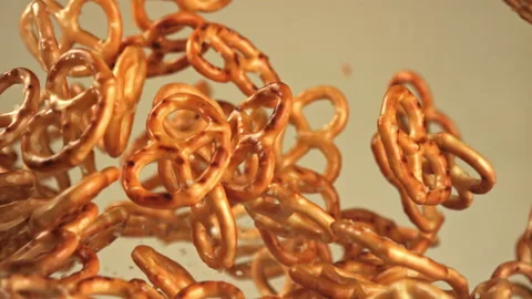 Salty pretzels fly up and fall on a light background. Filmed on a high-speed Stock Footage 322826035
