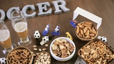 Salty snacks and drinks on the table for soccer party. Stock Footage