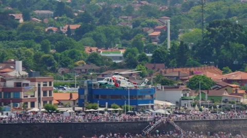 Salvamento Maritimo helicopter flying over Gijon waterfront crowd Stock-Footage 336281078