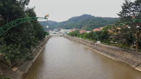 Sam Neua river, dragon lanterns, tree covered mountains, houses on river banks Stockbeeldmateriaal 76796397