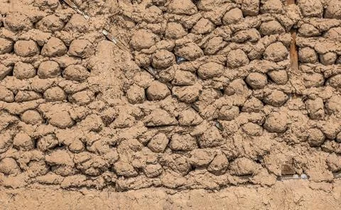 Saman adobe wall made with round bricks, texture and background Stock Photos