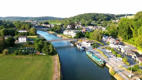 Sambre River flows quietly past Namur town, surrounded by lush forests Stock Footage 340271069