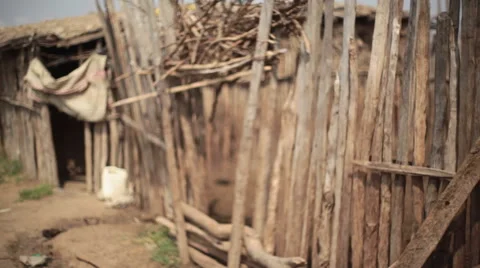 Samburu tribe woman carry water into mud house Kenya Africa