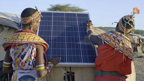 Samburu women installing a solar panel. Kenya. Stock Footage