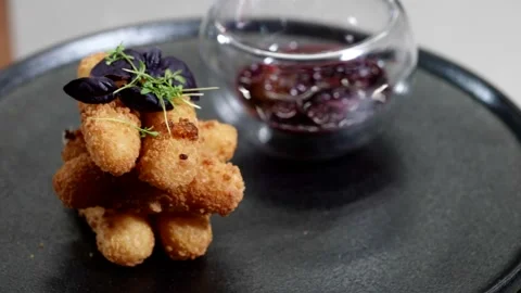 The same set: breadcrumbs, basil, berries in syrup, glass serving, black plate. 動画素材 313868773
