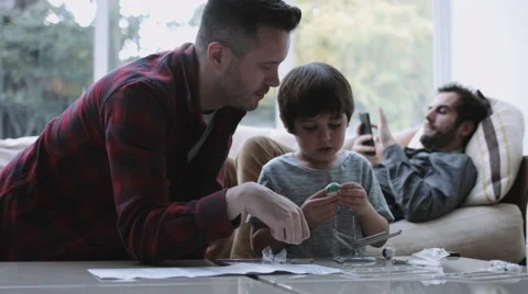 Same sex couple family together, Father and son playing and painting Stock Footage