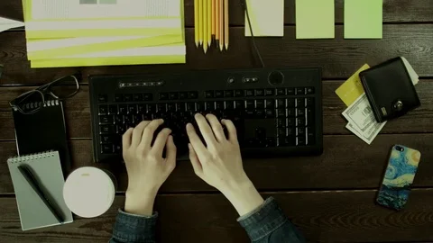 At the same time drinking coffee and typing on a keyboard. Stock Footage 82008642