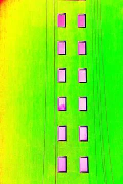 The same windows on the wall of a tall building, urbanism. Changed color sc.. Ilustración de archivo