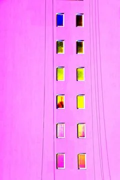 The same windows on the wall of a tall building, urbanism. Changed color sc.. Ilustración de archivo