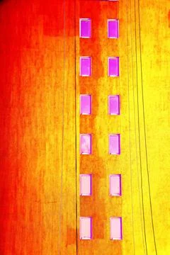 The same windows on the wall of a tall building, urbanism. Changed color sc.. Stock Illustration