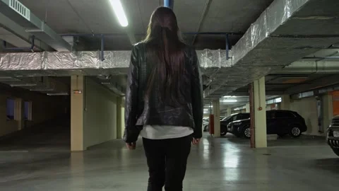 Сamera moves from behind a man walking through an underground car park Stock Footage 287915938