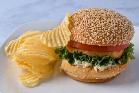 Samon burgerwith a side of potato chips, Stock Photos